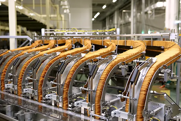 Automated industrial packaging system with multiple conveyor belts transporting items through production lines in a manufacturing setting.