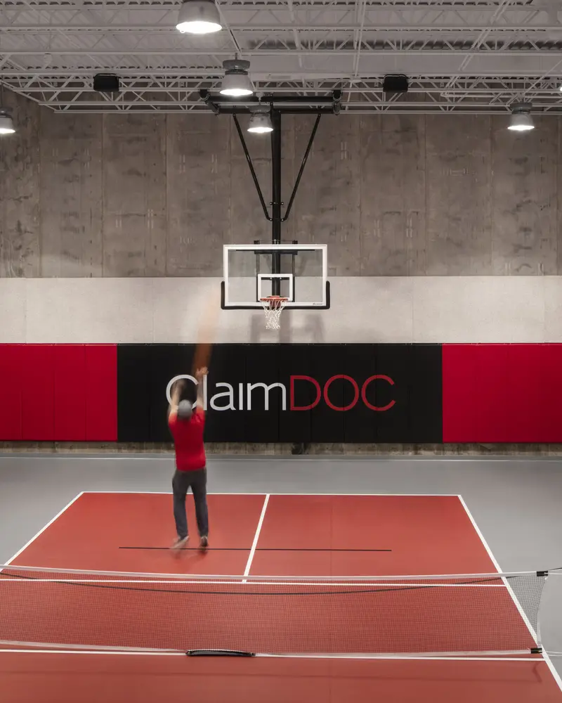 Man playing basketball at ClaimDoc Headquarters Gym